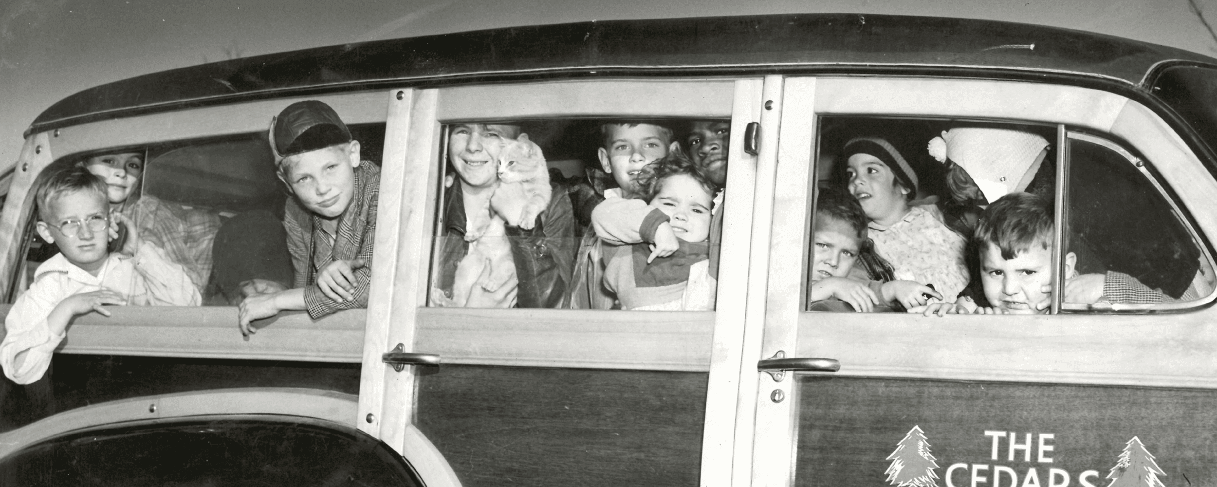 Old black and white photo of kids in a CEDARS van